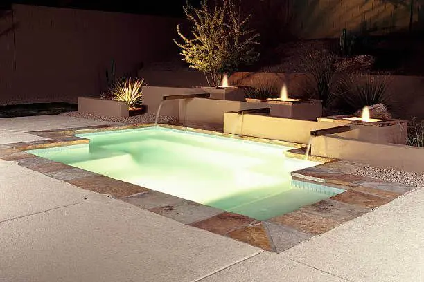 stamped concrete is installed around the swimming pool